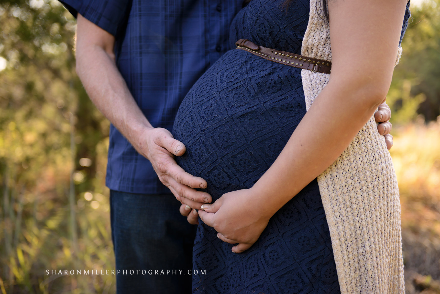 photo of parent's hands cradling belly by Highland Village maternity photographer Sharon Miller