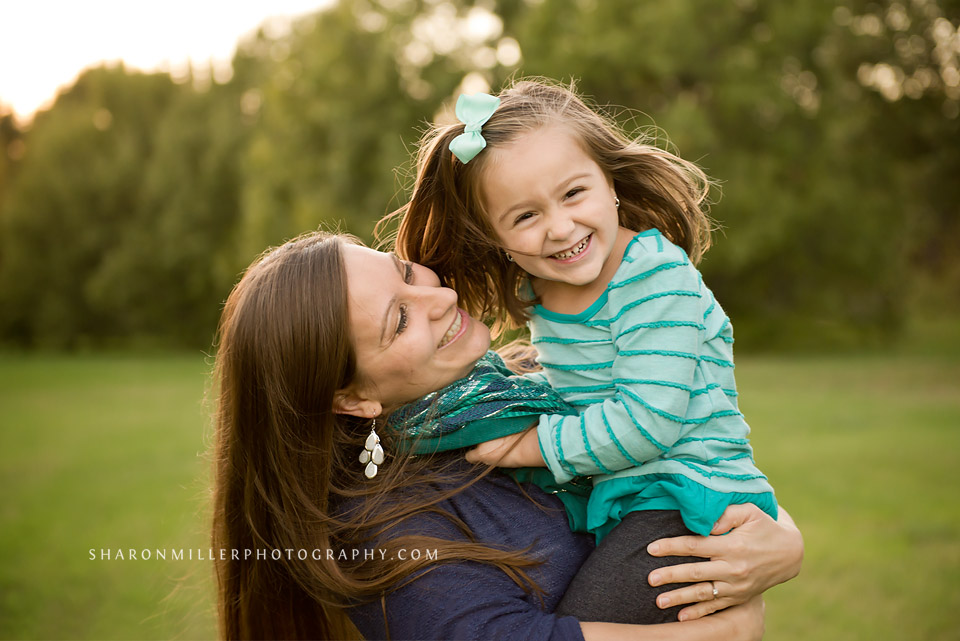 Mom playing with her spunky youngest daughter during a family lifestyle session by Grapevine family photographer