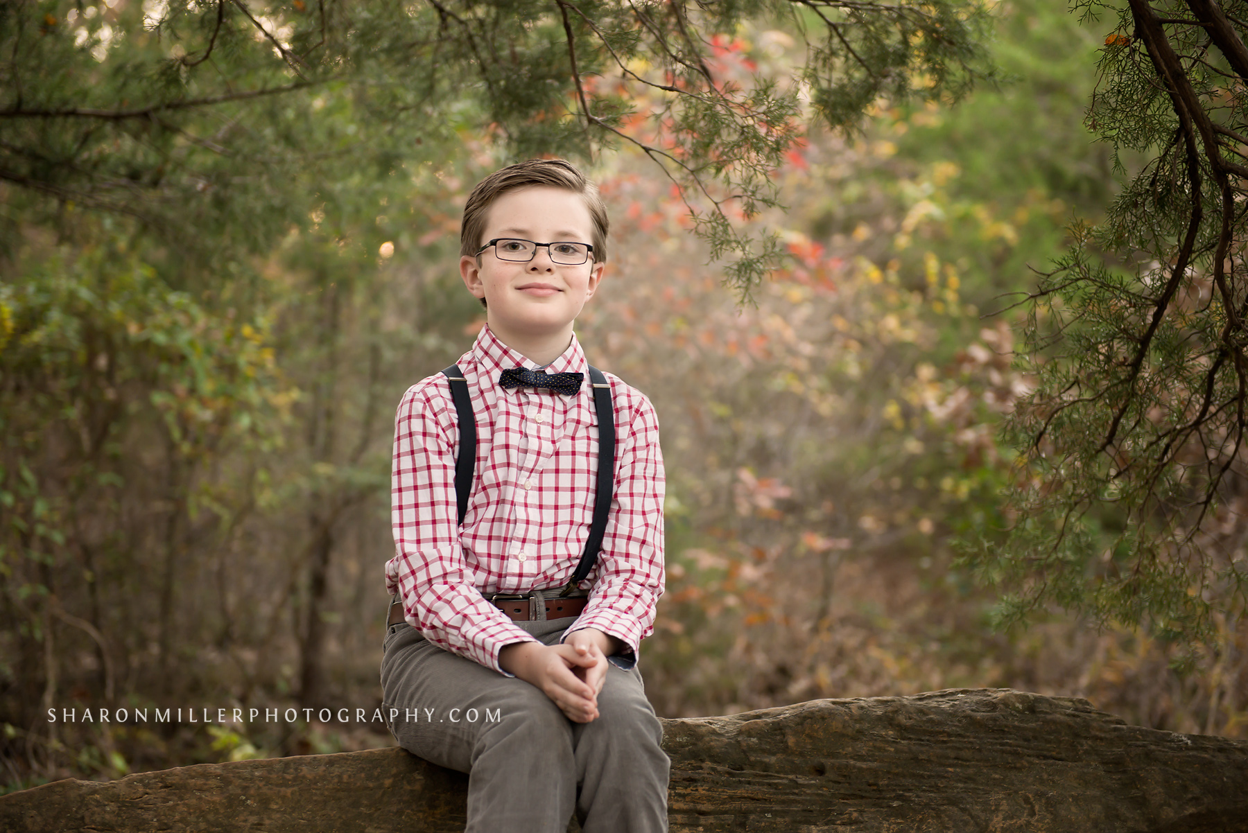 portrait of boy with suspenders and bow tie by Flower Mound family photographer Sharon Miller