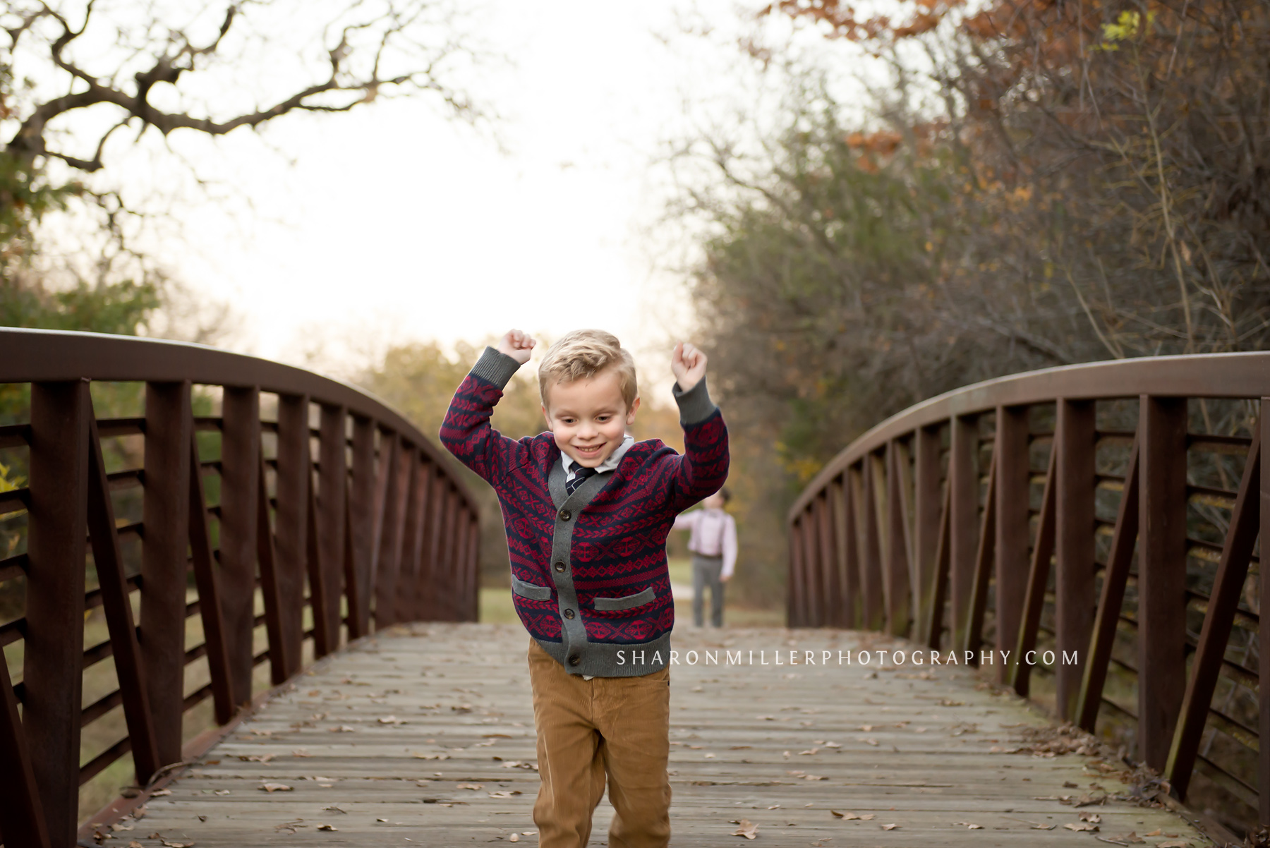 photo of boy joyfully running over a bridge at Stone Creek in Flower Mound