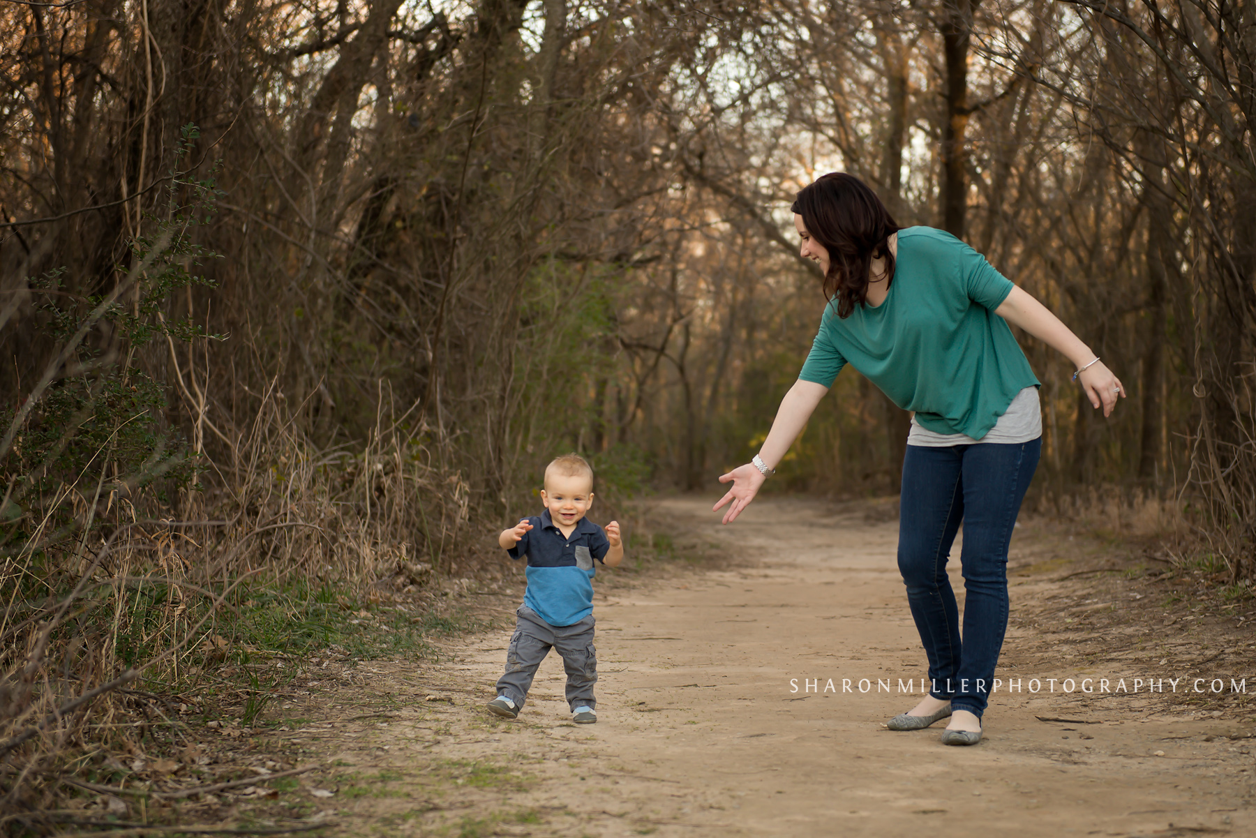 one year old walking with mother on Colleyville Nature Center trail