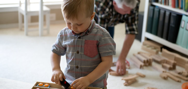 grandpa and grandson cleaning up train set-photographing everyday stories